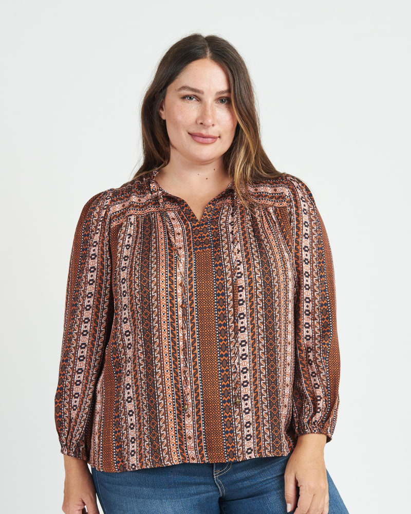 Front of a model wearing a size 2X Taliyah Long Sleeve Top with Split-Neck and Tassels in N408 Rust by Daniel Rainn. | dia_product_style_image_id:272100